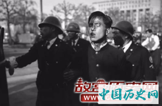 5月暴动(May Day riots)期间，一名被警方带走的反对派。1952年5月1日